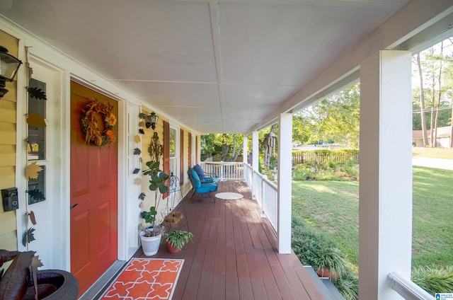 wooden terrace with a yard and a porch