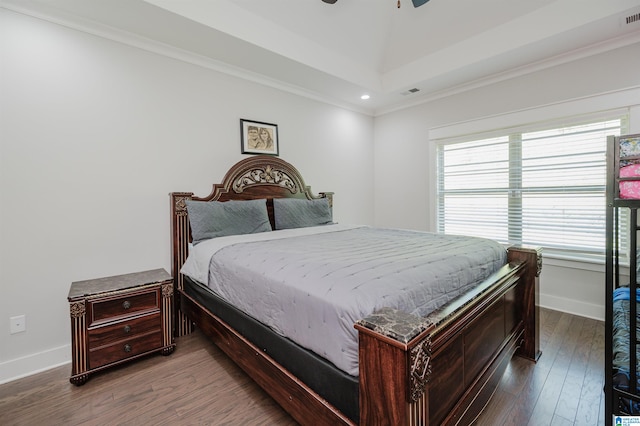 bedroom with ornamental molding, dark hardwood / wood-style flooring, and ceiling fan