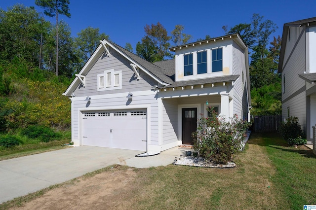 view of front of house featuring a front lawn and a garage