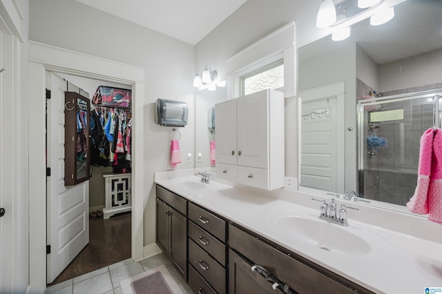 bathroom with hardwood / wood-style floors, walk in shower, and vanity