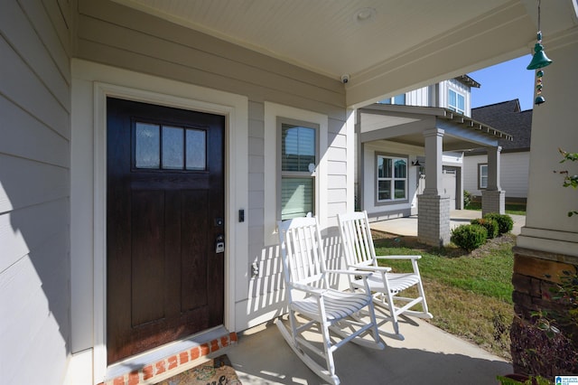 view of exterior entry with covered porch