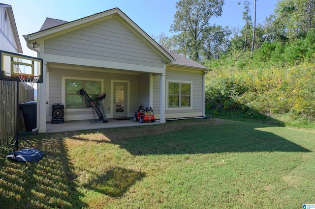 rear view of property featuring a lawn