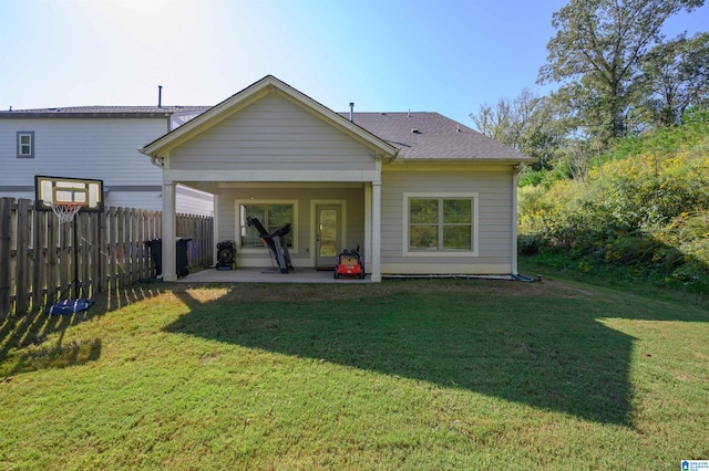 rear view of house with a lawn and a patio area