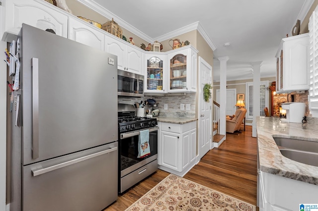 kitchen with white cabinetry, light stone countertops, dark wood-type flooring, and stainless steel appliances