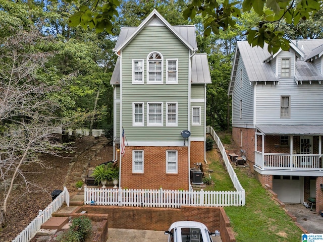 view of front facade featuring central AC unit and a garage