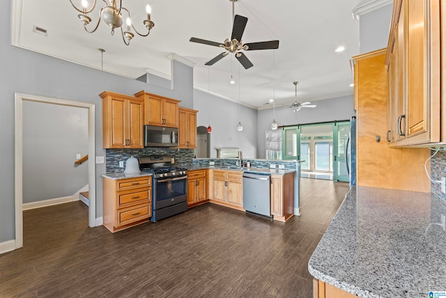 kitchen featuring light stone counters, stainless steel appliances, kitchen peninsula, and dark hardwood / wood-style flooring