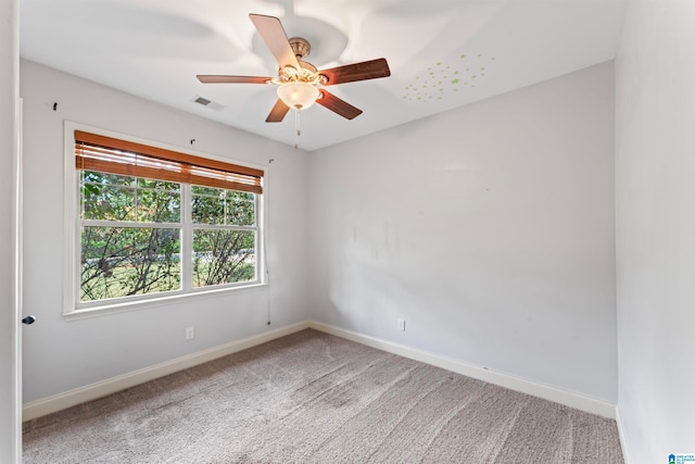 spare room featuring ceiling fan and carpet flooring