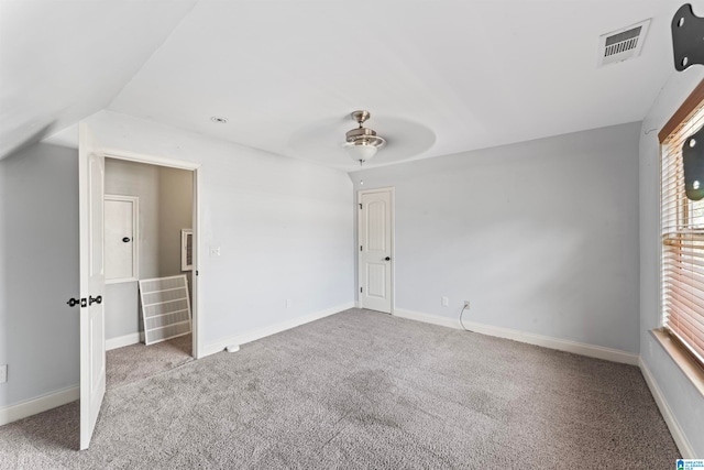 carpeted spare room with lofted ceiling and ceiling fan