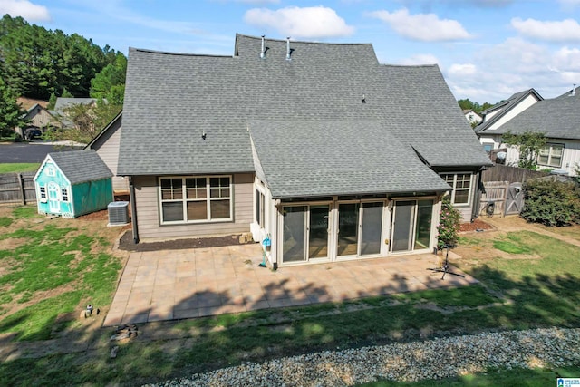 rear view of property featuring a shed, a patio, and central air condition unit