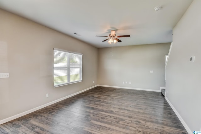 empty room with ceiling fan and dark hardwood / wood-style floors