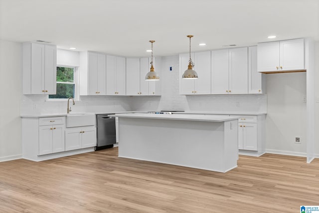 kitchen featuring pendant lighting, white cabinetry, a center island, and stainless steel dishwasher