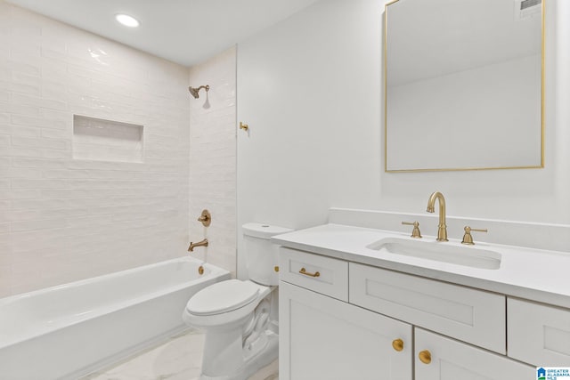 full bathroom featuring vanity, tiled shower / bath combo, and toilet