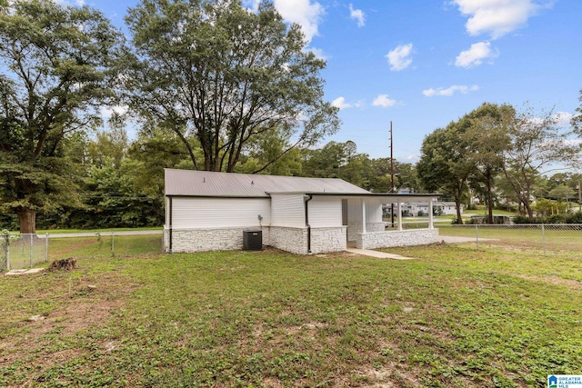 rear view of property with a yard