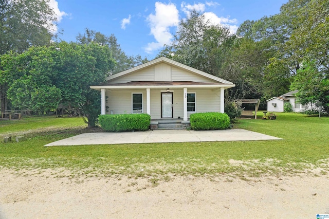 bungalow-style home featuring a front yard and covered porch