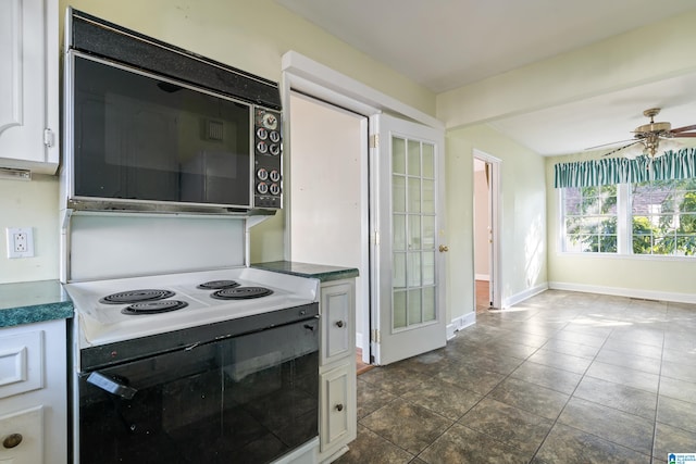 kitchen with ceiling fan, white cabinets, white electric range, and dark tile patterned flooring