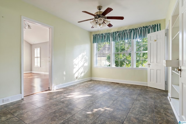 empty room with ceiling fan and dark hardwood / wood-style floors