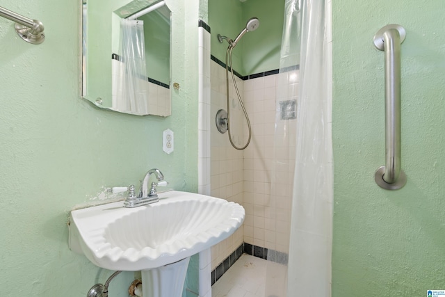 bathroom with sink and a shower with curtain