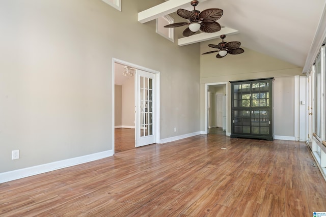 interior space featuring high vaulted ceiling, light hardwood / wood-style flooring, beamed ceiling, and ceiling fan