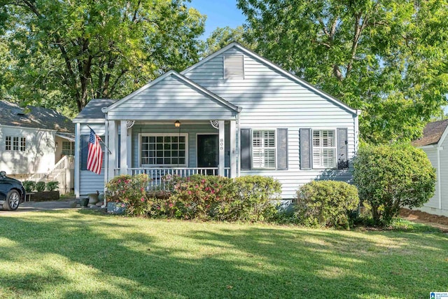 bungalow-style house featuring a front lawn and covered porch