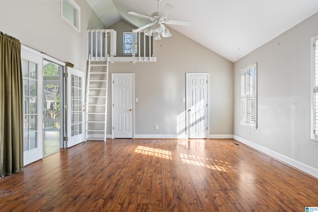 empty room with dark hardwood / wood-style floors, high vaulted ceiling, and ceiling fan