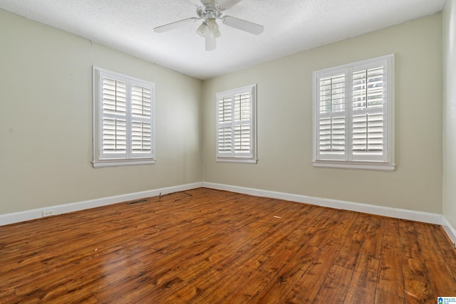 unfurnished room featuring ceiling fan, hardwood / wood-style flooring, and a textured ceiling