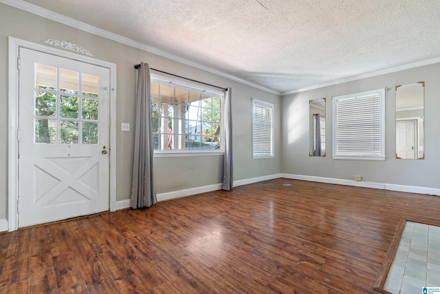 foyer entrance with dark wood-type flooring, crown molding, and a textured ceiling