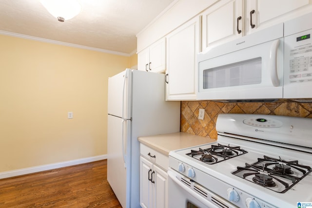 kitchen with white cabinets, white appliances, tasteful backsplash, crown molding, and dark hardwood / wood-style flooring