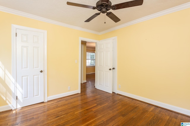 spare room with ornamental molding, ceiling fan, dark hardwood / wood-style floors, and a textured ceiling