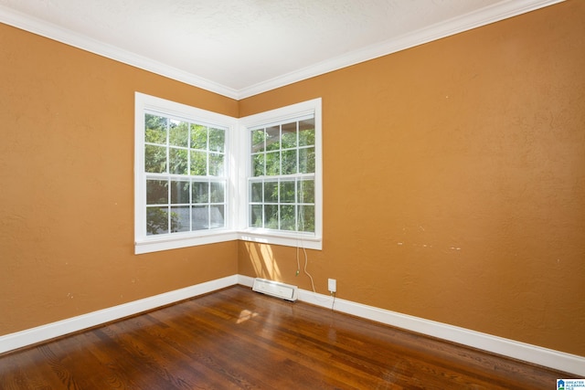 empty room featuring a textured ceiling, hardwood / wood-style flooring, and crown molding