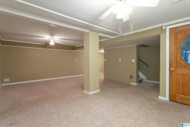 basement with crown molding, ceiling fan, and light colored carpet