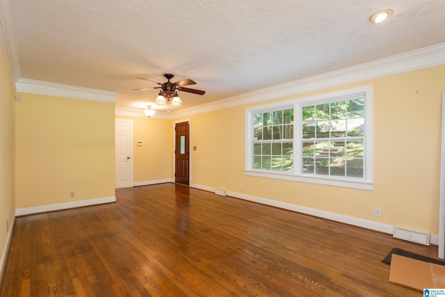 empty room with a textured ceiling, ornamental molding, and dark hardwood / wood-style flooring