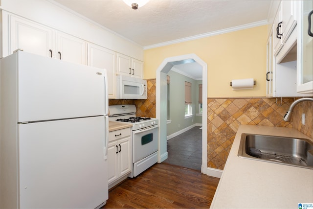 kitchen with white cabinets, white appliances, ornamental molding, dark hardwood / wood-style floors, and sink