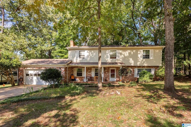 view of front of house with a garage and a front lawn