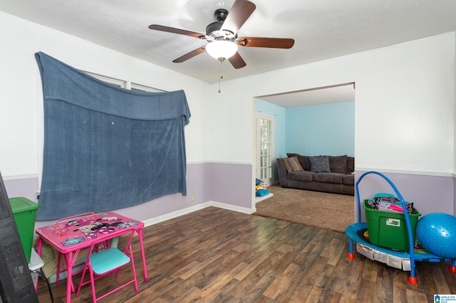 game room featuring dark hardwood / wood-style floors and ceiling fan