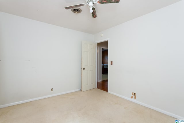 carpeted spare room with ceiling fan