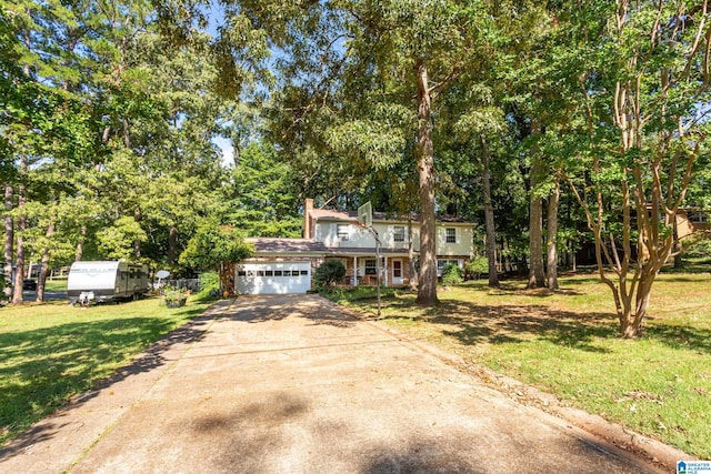 view of front facade with a garage and a front lawn