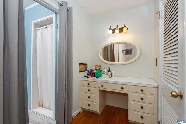 bathroom featuring curtained shower, vanity, and hardwood / wood-style floors