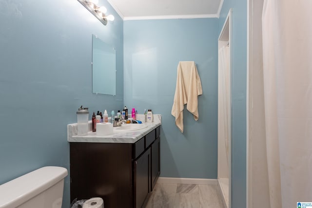 bathroom featuring a shower with shower curtain, crown molding, vanity, and toilet