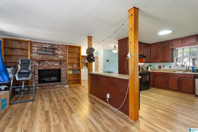 kitchen featuring light hardwood / wood-style flooring, a textured ceiling, electric range, and sink