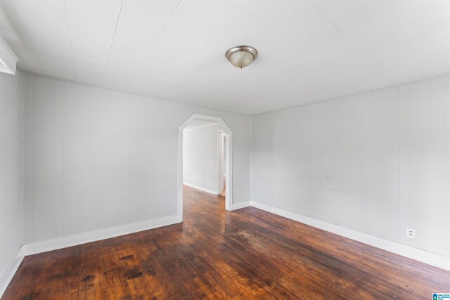 unfurnished room featuring dark hardwood / wood-style flooring