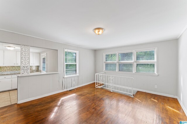 spare room with ornamental molding and dark hardwood / wood-style flooring