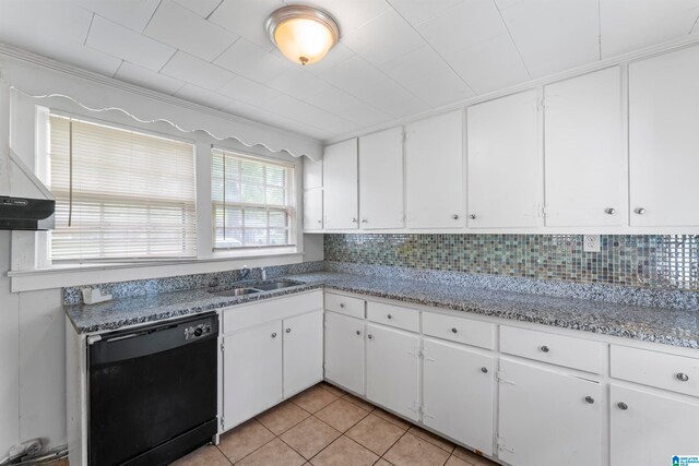 kitchen with white cabinets, black dishwasher, tasteful backsplash, and light tile patterned flooring