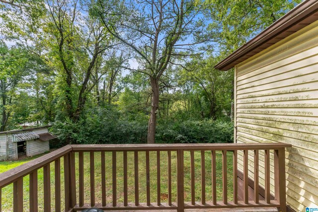 deck featuring a yard and a storage unit