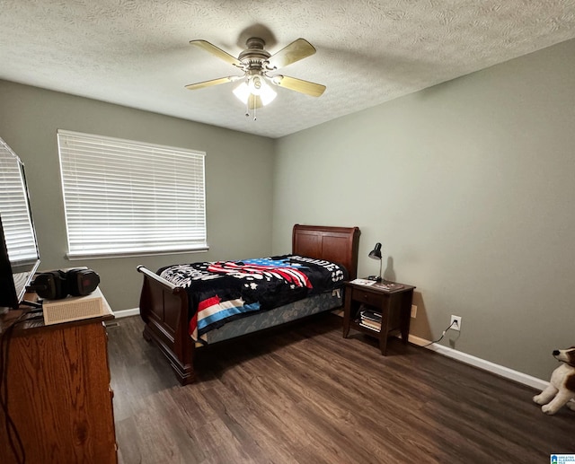 bedroom featuring ceiling fan, a textured ceiling, and dark hardwood / wood-style floors