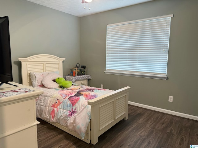 bedroom featuring ceiling fan, a textured ceiling, and dark wood-type flooring