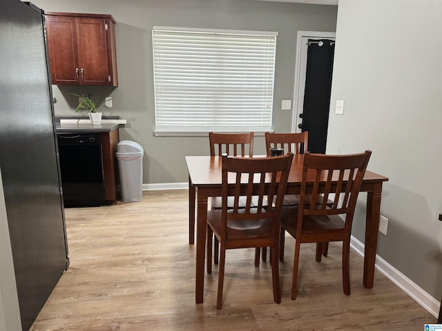 dining area with light hardwood / wood-style floors