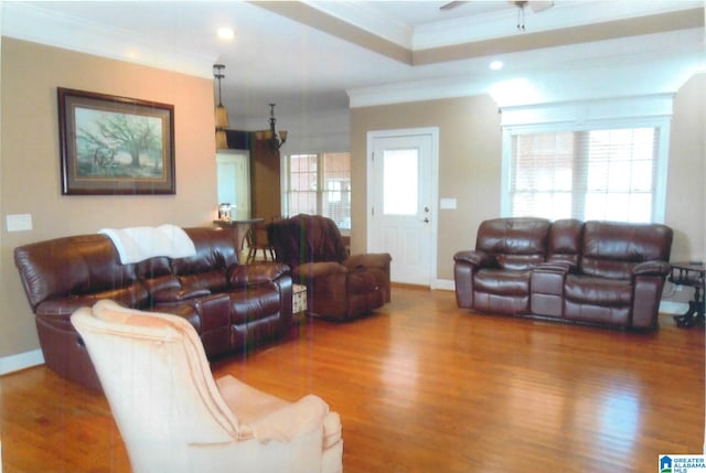 living room featuring wood-type flooring, ornamental molding, and ceiling fan