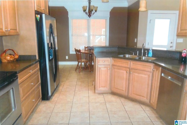 kitchen with plenty of natural light, a chandelier, appliances with stainless steel finishes, and hanging light fixtures