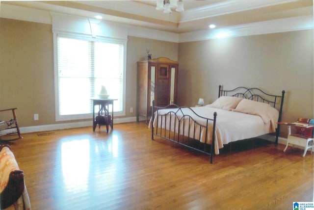 bedroom featuring crown molding and hardwood / wood-style floors