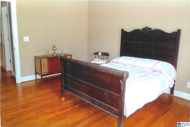 bedroom with hardwood / wood-style floors